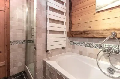 a bathroom with a white tub and a shower at Le Gite - L'oréade - 6 pax in Saint-Gervais-les-Bains