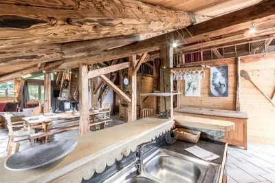 a kitchen in a log cabin with a sink at Le Gite - Le Mont Blanc - 9 pax in Saint-Gervais-les-Bains