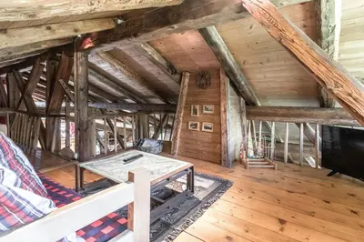 a room with a table in a attic at Le Gite - Le Mont Blanc - 9 pax in Saint-Gervais-les-Bains