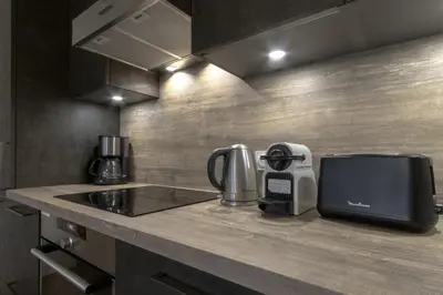 a kitchen counter with a coffee maker and a toaster at Le 201 - Proche Centre Ville - Ski In - Ski Out in Saint-Gervais-les-Bains