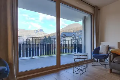 a living room with a large sliding glass door at Le 201 - Proche Centre Ville - Ski In - Ski Out in Saint-Gervais-les-Bains
