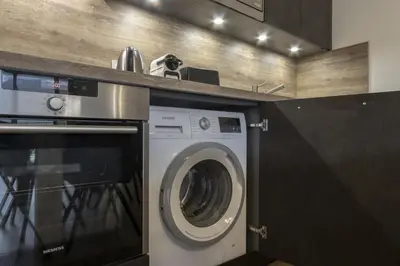 a laundry room with a washing machine and a counter at Le 201 - Proche Centre Ville - Ski In - Ski Out in Saint-Gervais-les-Bains
