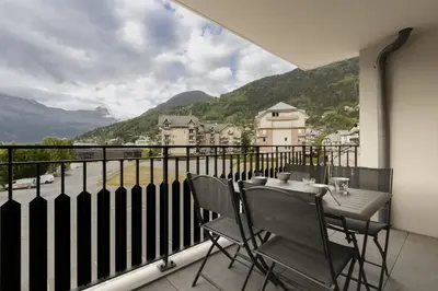 a balcony with a table and chairs and a view at Le 201 - Proche Centre Ville - Ski In - Ski Out in Saint-Gervais-les-Bains