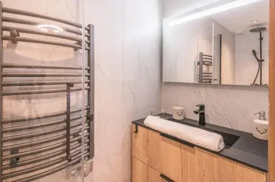 a bathroom with a sink and a mirror at Appartement Capra - Welkeys in Megève