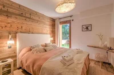 a bedroom with a large bed with towels on it at Appartement Capra - Welkeys in Megève
