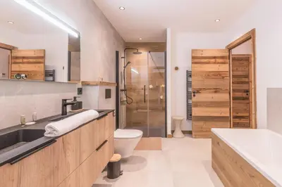 a bathroom with a sink and a toilet and a shower at Appartement Capra - Welkeys in Megève