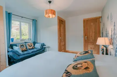 a bedroom with a bed and a window and a couch at Au pied du télécabine & gare St Gervais in Saint-Gervais-les-Bains