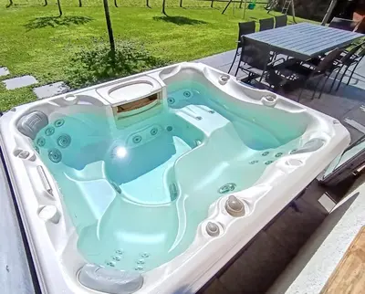 a jacuzzi tub sitting on top of a patio at Chalet Josaly Jacuzzi et Sauna in Samoëns