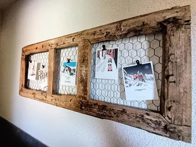 a wooden picture frame with pictures on a wall at Chalet Josaly Jacuzzi et Sauna in Samoëns