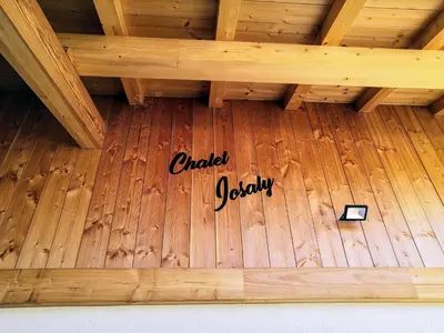 a wooden floor with a sign that reads contact jolly at Chalet Josaly Jacuzzi et Sauna in Samoëns