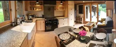 a kitchen and living room with a table and chairs at Mini Chalet vue montagne in Les Houches
