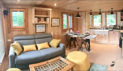 a living room and kitchen in a tiny house at Mini Chalet vue montagne in Les Houches