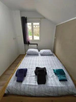 a bedroom with two beds with towels on it at Cosy F2 in Passy