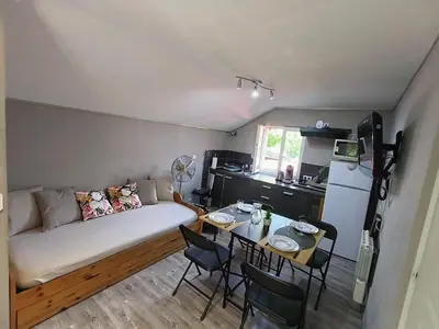 a small living room with a couch and a table at Cosy F2 in Passy