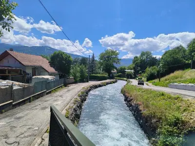 a small river on a road with a bridge at Cosy F2 in Passy
