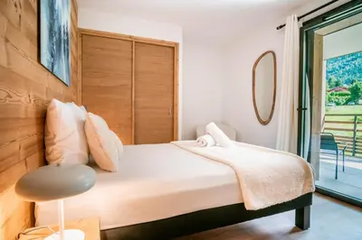 a bedroom with a large bed and a window at La terrasse des Aiguilles - Magnifiques vues in Les Houches
