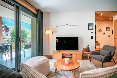 a living room with a tv and a couch at La terrasse des Aiguilles - Magnifiques vues in Les Houches