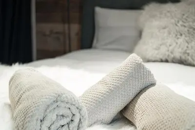 a pair of socks on top of a bed at Chaleureux Chalet Familial - Vue époustouflante in Combloux