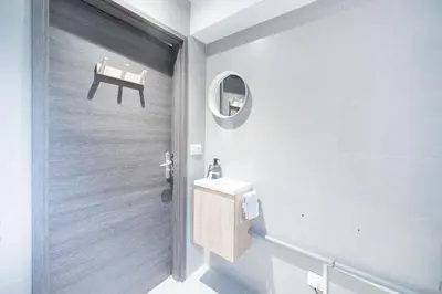 a bathroom with a sink and a mirror and a chair at Chaleureux Chalet Familial - Vue époustouflante in Combloux