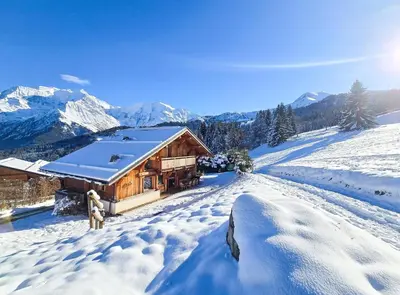 a log cabin in the mountains in the snow at Chalet Vallée de Chamonix, Ski, Snow, Spa vue MontBlanc by ImmoConciergerie in Saint-Gervais-les-Bains