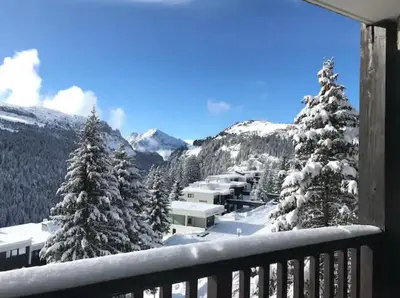 a view from a balcony with snow covered trees at Appartement à 20m des pistes, avec piscine et sauna in Arâches-la-Frasse