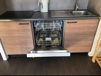 a dish washer in a kitchen under a sink at Appartement à 20m des pistes, avec piscine et sauna in Arâches-la-Frasse