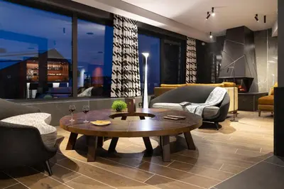 a hot tub in a room with two chairs at MGM Hôtels & Résidences - Hôtel Laska in Les Contamines-Montjoie