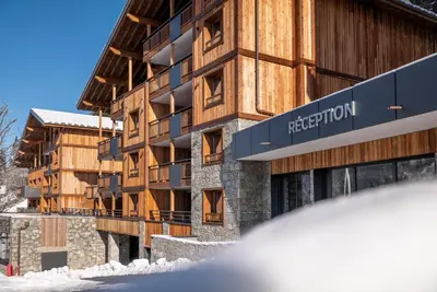 a group of buildings in the snow at MGM Hôtels & Résidences - Hôtel Laska in Les Contamines-Montjoie