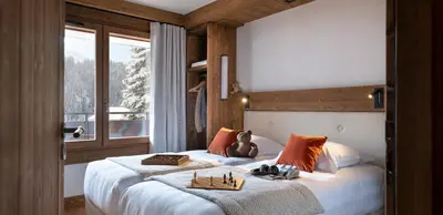 a living room with a couch and a table at MGM Hôtels & Résidences - Hôtel Laska in Les Contamines-Montjoie