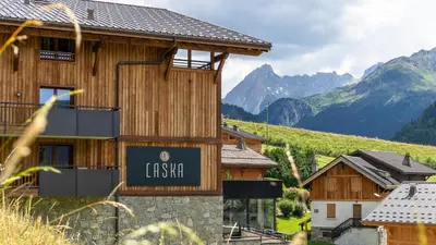 a restaurant with a bar with a table and chairs at MGM Hôtels & Résidences - Hôtel Laska in Les Contamines-Montjoie
