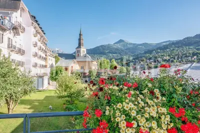 a view of a town with flowers and a church at Grand Panorama 216 - 2 bed Apt, next to Bettex lift, sleeps 6 in Saint-Gervais-les-Bains