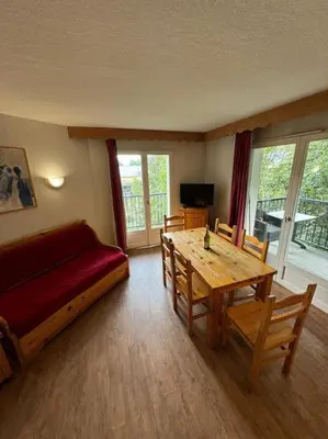 a living room with a couch and a table at Grand Panorama 216 - 2 bed Apt, next to Bettex lift, sleeps 6 in Saint-Gervais-les-Bains
