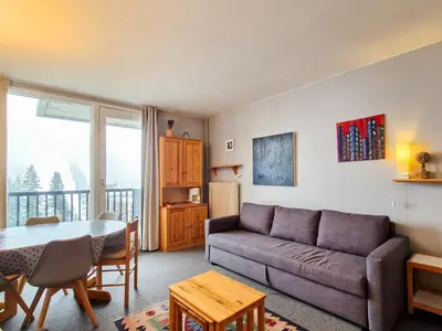a living room with a couch and a table at Studio lumineux avec balcon - Proche des pistes et commerces - FR-1-425-226 in Arâches-la-Frasse