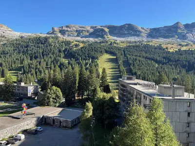 a person standing in a parking lot in front of a mountain at Studio lumineux avec balcon - Proche des pistes et commerces - FR-1-425-226 in Arâches-la-Frasse