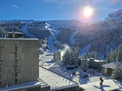 a view of a snow covered mountain from a building at Studio lumineux avec balcon - Proche des pistes et commerces - FR-1-425-226 in Arâches-la-Frasse