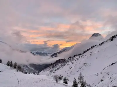a snow covered mountain with clouds in the sky at Appartement vue Montblanc 5mn piste2 in Les Trabets