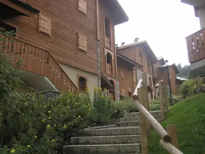 a brick building with stairs in front of a building at Bel appartement 3 ch, au pied des pistes avec wifi - FR-1-642-93 in Morillon