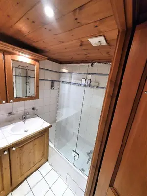 a bathroom with a shower and a sink at La Ginabelle – vue Mont Blanc avec piscine in Chamonix-Mont-Blanc