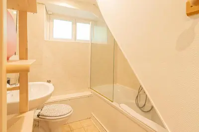 a bathroom with a toilet and a sink and a bath tub at Rimaye Blanche - A bright and cozy 1 bed apartment in Chamonix-Mont-Blanc