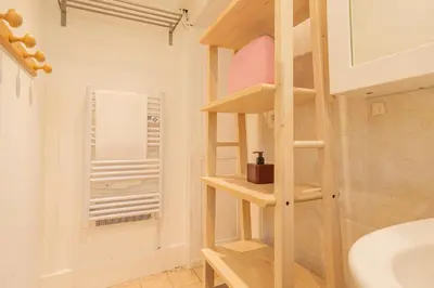 a bathroom with a wooden book shelf in a bathroom at Rimaye Blanche - A bright and cozy 1 bed apartment in Chamonix-Mont-Blanc