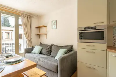 a living room with a couch and a table at Bois des Fées - newly renovated central Chamonix apartment in Chamonix-Mont-Blanc