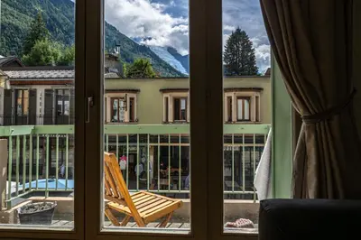 a window with a view of a building at Bois des Fées - newly renovated central Chamonix apartment in Chamonix-Mont-Blanc