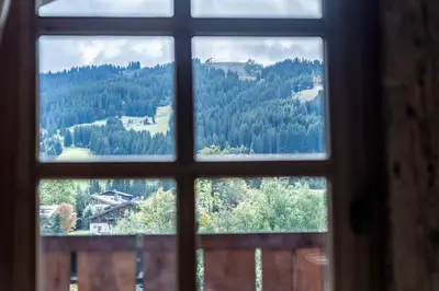 a view of a mountain through a window at Chalet Mont d'Arbois Ski et Golf in Megève