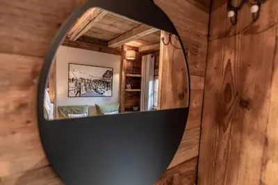 a mirror on a wall in a room at Chalet Mont d'Arbois Ski et Golf in Megève