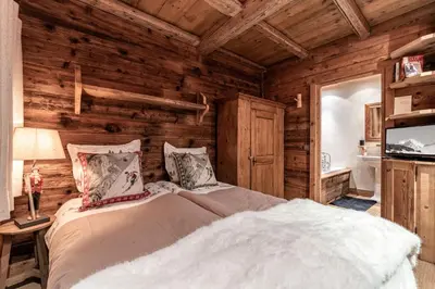 a bedroom with a bed in a log cabin at Chalet Mont d'Arbois Ski et Golf in Megève