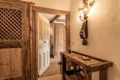a room with a wooden door and a wooden table at Chalet Mont d'Arbois Ski et Golf in Megève