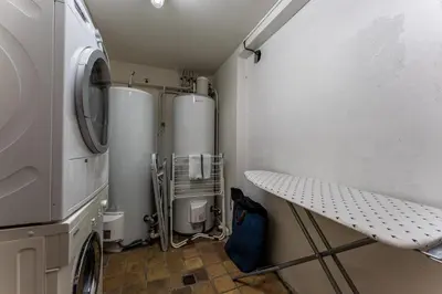 a laundry room with two refrigerators and a table at Chalet Mont d'Arbois Ski et Golf in Megève