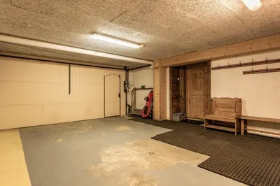 an empty garage with a basketball court and a bench at Chalet Mont d'Arbois Ski et Golf in Megève