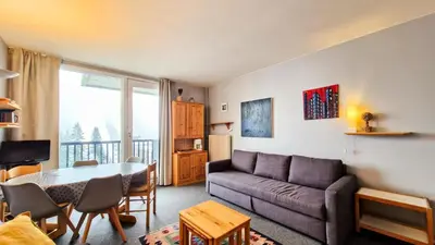 a living room with a couch and a table at Résidence Vega - Studio lumineux · Proche des pistes et des commerces · Balcon MAE-1641 in Magland