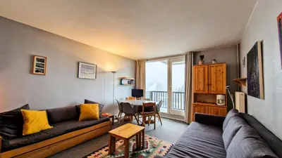 a living room with a couch and a table at Résidence Vega - Studio lumineux · Proche des pistes et des commerces · Balcon MAE-1641 in Magland